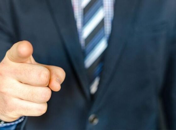 A man is fired after cutting his salary by half to keep his job.