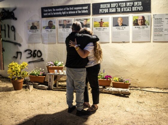 Two people embrace at a memorial ceremony for the victims of the 2023 October 7 attacks at the Nova Festival grounds.