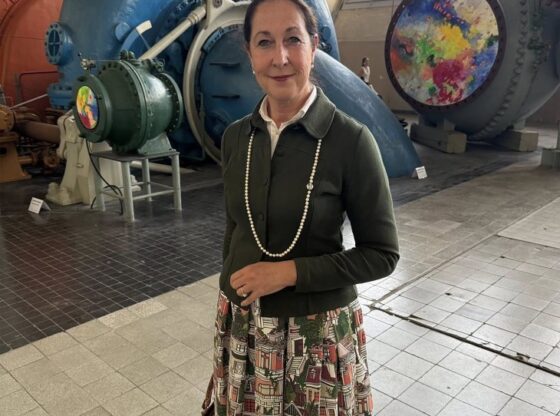 Iris Stalzer standing in front of large industrial equipment.