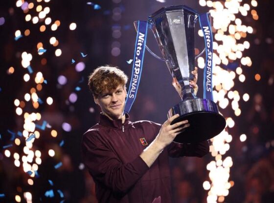 Italy's Jannik Sinner celebrates with his trophy after winning the ATP finals against Spain's Carlos Alcaraz in Turin, Italy, on November 16, 2025.