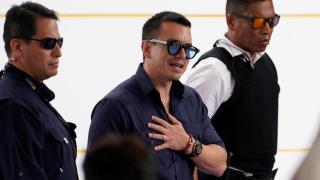 The president of Ecuador, Daniel Noboa, escorted by two bodyguards during an event.