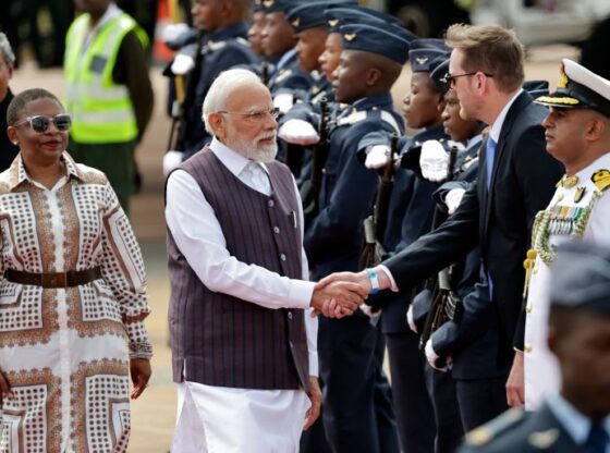 Indian Prime Minister Narendra Modi, center, is welcomed on his arrival at the Air Force Base Waterkloof, near Pretoria, South Africa, Friday Nov. 21, 2025, ahead of the G20 Summit. (Kim Ludbrook/Pool Photo via AP)