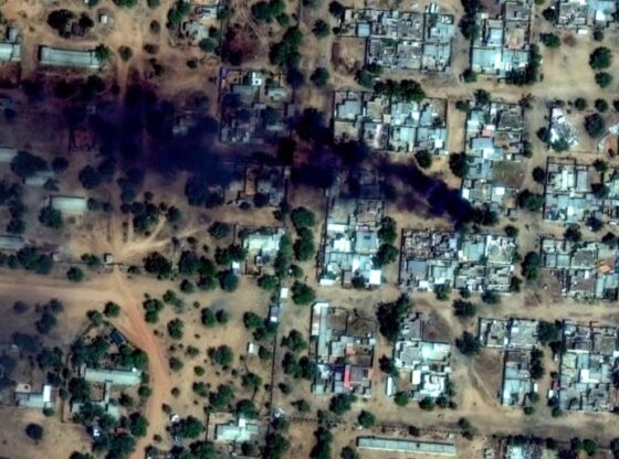 Plumes of smoke rise in a neighborhood near El Fasher Airport